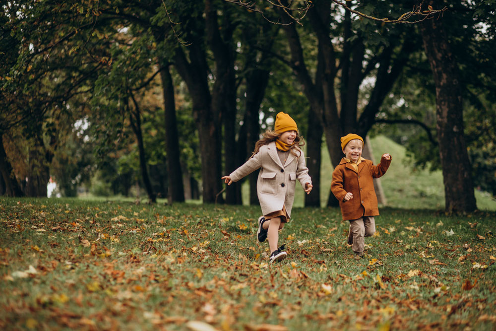Kinder spielen draußen im Herbst