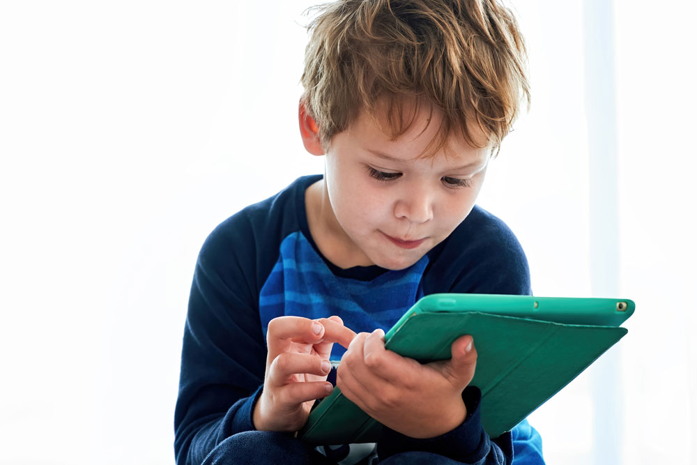 Ein Grundschulkind nutzt am Tablet interaktive Mathe-Übungen mit direktem Feedback.